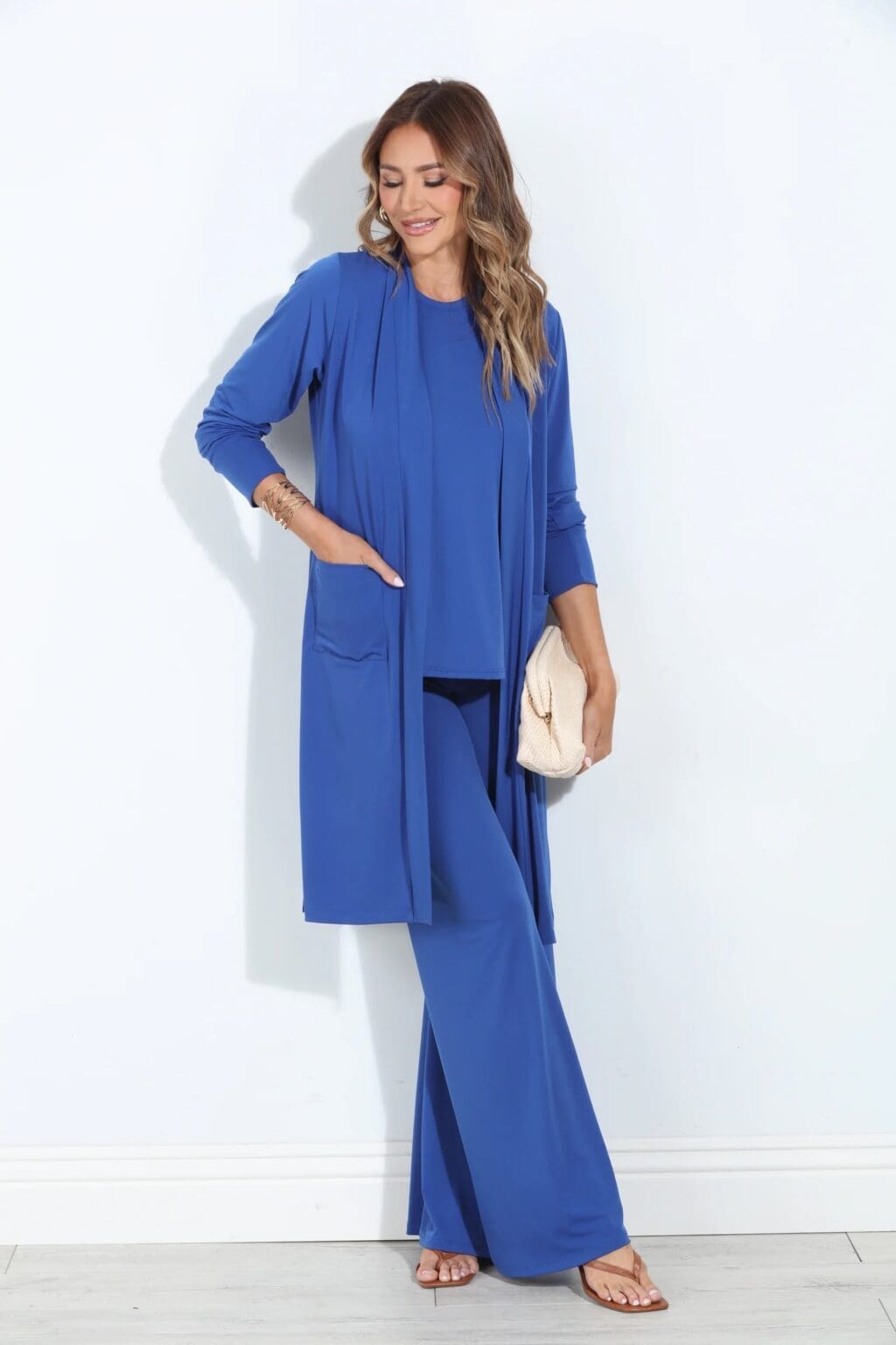 High Waist Boot Cut Stretch Pants 4 Woman wearing black flare stretch pants paired with a mid-length cardigan and racerback top – coordinated loungewear set made in South Africa