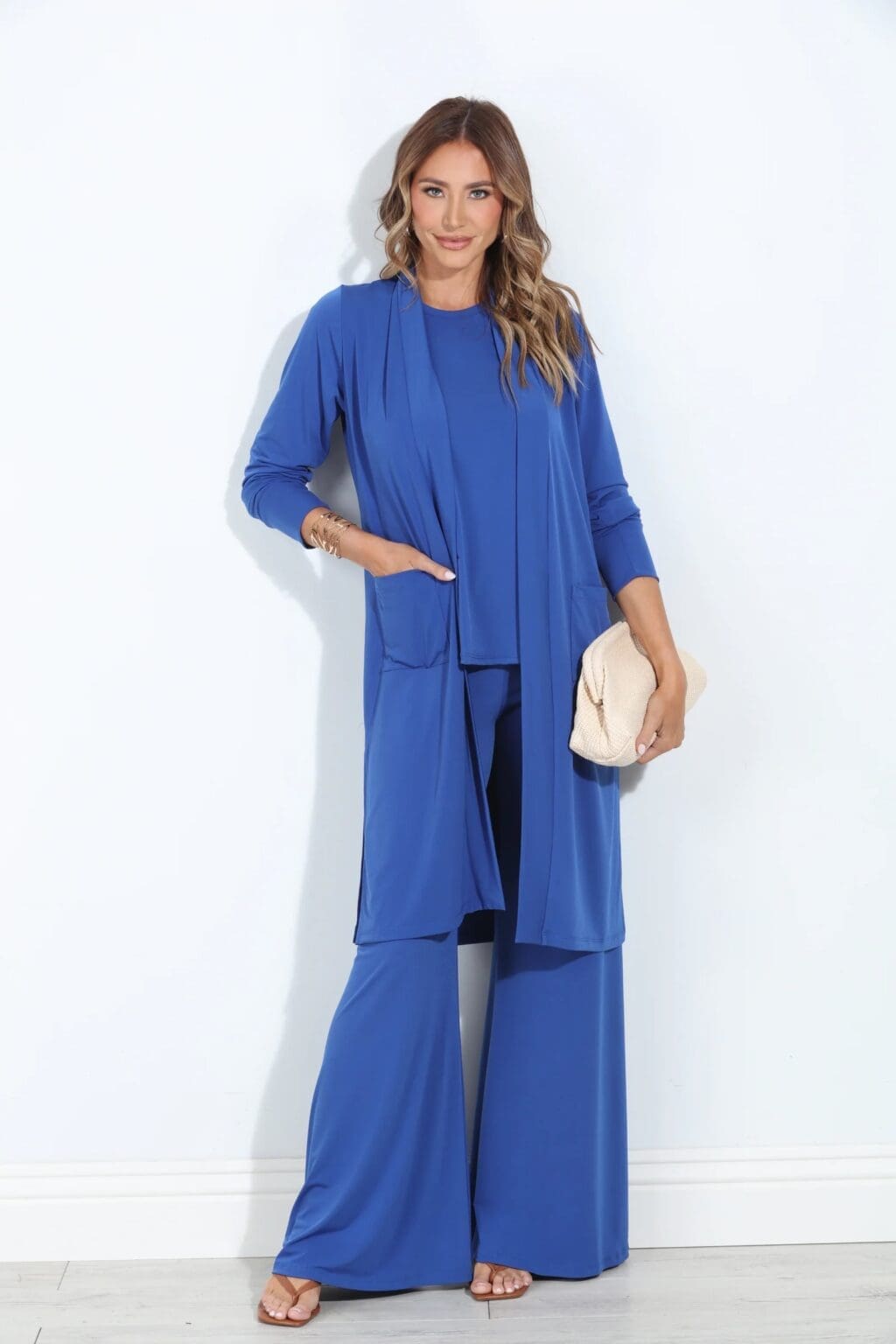 High Waist Boot Cut Stretch Pants Blue Set Woman wearing black flare stretch pants paired with a mid-length cardigan and racerback top – coordinated loungewear set made in South Africa