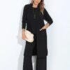 Woman wearing black flare stretch pants paired with a mid-length cardigan and racerback top – coordinated loungewear set made in South Africa Woman wearing black flare stretch pants paired with a mid-length cardigan and racerback top – coordinated loungewear set made in South Africa